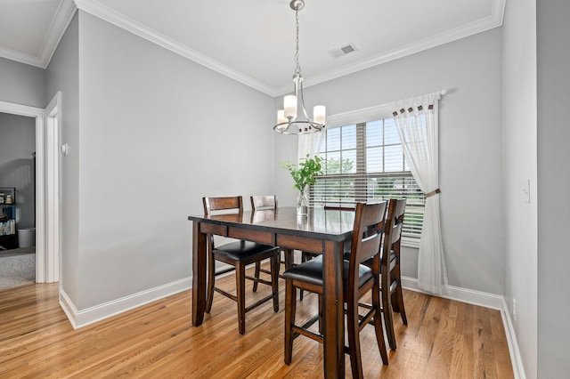 2520 Pebblecreek Ln, Murfreesboro, TN 37130 - dining room featuring baseboards, light wood-style floors, crown molding, and a chandelier