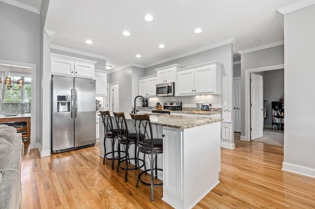 2520 Pebblecreek Ln, Murfreesboro, TN 37130 - kitchen featuring stainless steel appliances, white cabinets, an island with sink, light wood-type flooring, and recessed lighting