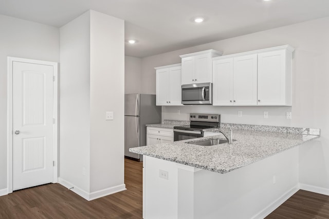 2045 Lala Loop, White Bluff, TN 37187 - kitchen with stainless steel appliances, baseboards, a sink, dark wood finished floors, and recessed lighting