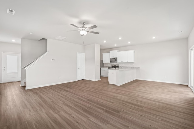 2045 Lala Loop, White Bluff, TN 37187 - unfurnished living room featuring wood finished floors, ceiling fan, baseboards, and recessed lighting