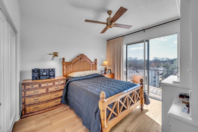 4215 Harding Pike Unit 610, Nashville, TN 37205 - bedroom featuring access to outside, light wood-style flooring, a textured ceiling, a ceiling fan, and a closet