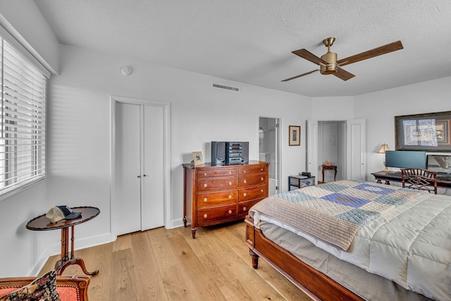 4215 Harding Pike Unit 610, Nashville, TN 37205 - bedroom with light wood-style flooring, multiple windows, a closet, ceiling fan, and a textured ceiling