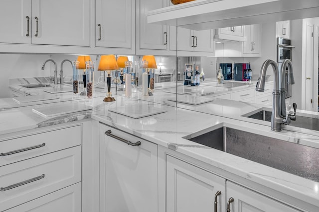4215 Harding Pike Unit 610, Nashville, TN 37205 - kitchen featuring a sink, white cabinetry, and light stone counters