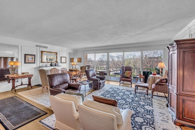 4215 Harding Pike Unit 610, Nashville, TN 37205 - living area featuring a textured ceiling, wood finished floors, and ornamental molding