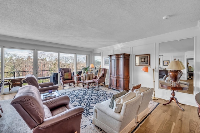 4215 Harding Pike Unit 610, Nashville, TN 37205 - living area featuring a textured ceiling, light wood-type flooring, and ornamental molding