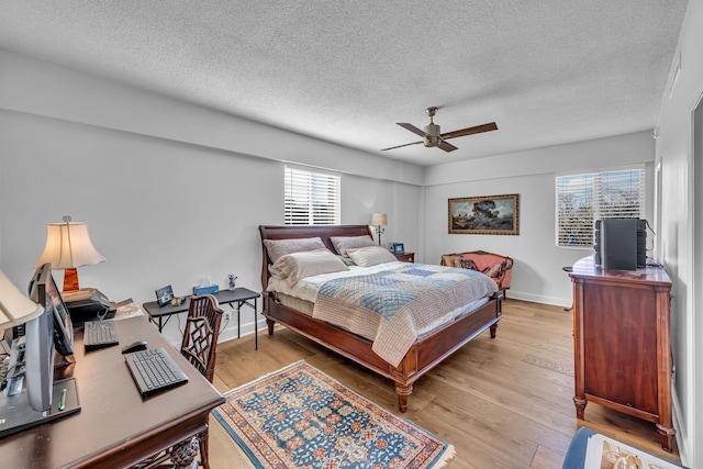 4215 Harding Pike Unit 610, Nashville, TN 37205 - bedroom featuring a textured ceiling, light wood-style flooring, a ceiling fan, and baseboards