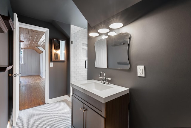 1305 Riverwood Dr, Nashville, TN 37216 - bathroom featuring lofted ceiling, vanity, baseboards, and wood finished floors