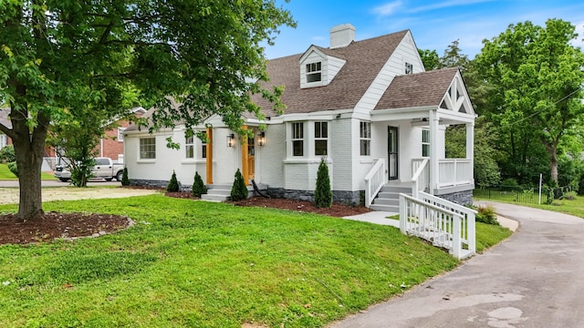 1305 Riverwood Dr, Nashville, TN 37216 - view of front of house featuring a front yard, asphalt driveway, a chimney, brick siding, and roof with shingles