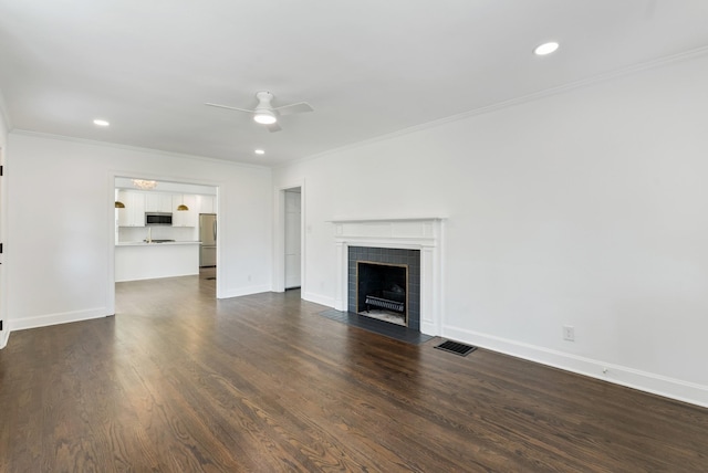 1305 Riverwood Dr, Nashville, TN 37216 - unfurnished living room with a ceiling fan, crown molding, a tile fireplace, baseboards, and dark wood-style flooring