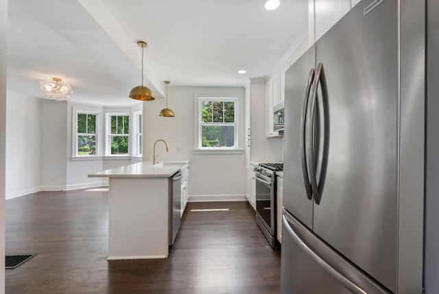 1305 Riverwood Dr, Nashville, TN 37216 - kitchen with appliances with stainless steel finishes, a sink, baseboards, white cabinets, and dark wood finished floors