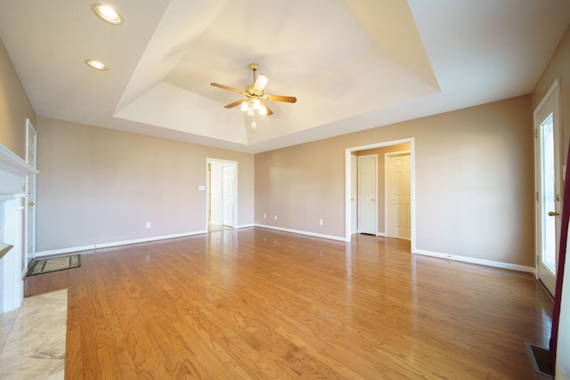 1101 Wedgewood Dr, Gallatin, TN 37066 - unfurnished living room featuring a tray ceiling, a ceiling fan, light wood-style floors, baseboards, and recessed lighting
