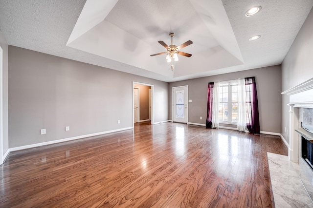 1101 Wedgewood Dr, Gallatin, TN 37066 - unfurnished living room with a raised ceiling, a ceiling fan, a high end fireplace, baseboards, and recessed lighting