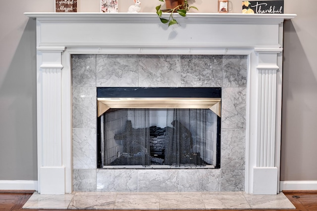 1101 Wedgewood Dr, Gallatin, TN 37066 - detailed view of a tiled fireplace, baseboards, and wood finished floors