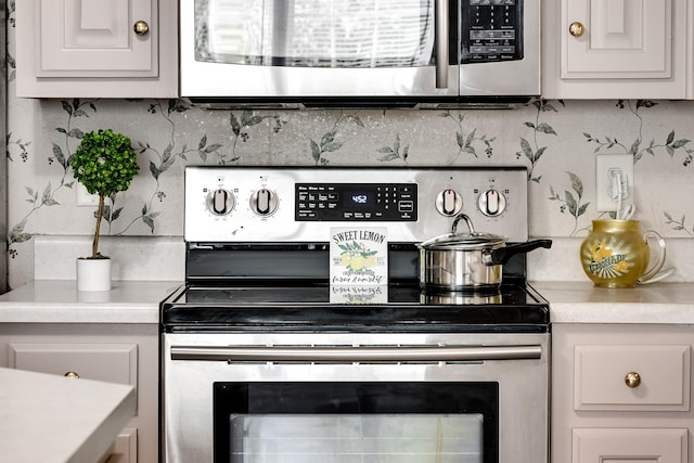 1101 Wedgewood Dr, Gallatin, TN 37066 - kitchen featuring stainless steel appliances, light countertops, and decorative backsplash