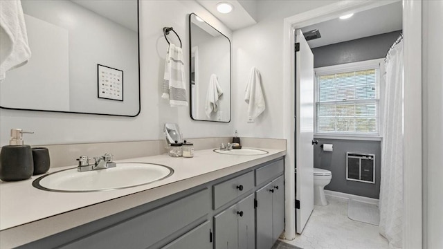 104 Oak Park Dr, Tullahoma, TN 37388 - full bathroom featuring double vanity, toilet, heating unit, and tile patterned floors