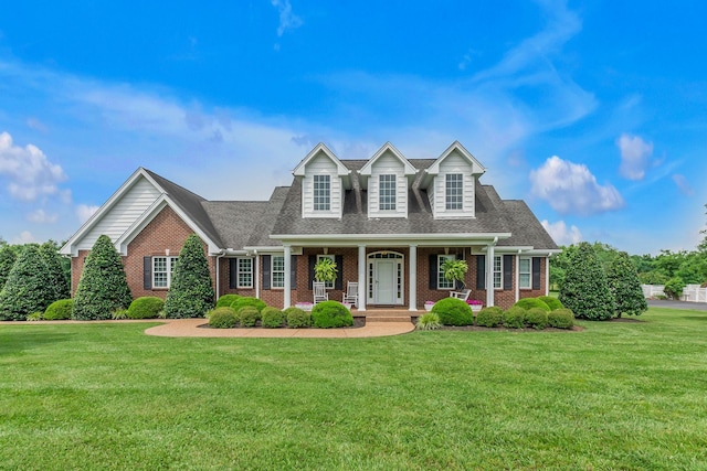 128 Mann Rd, Lebanon, TN 37087 - new england style home with brick siding, a front yard, and covered porch