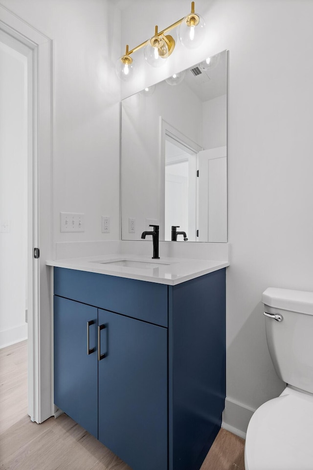 2522 E 18th St, Chattanooga, TN 37404 - bathroom featuring vanity, toilet, baseboards, and wood finished floors