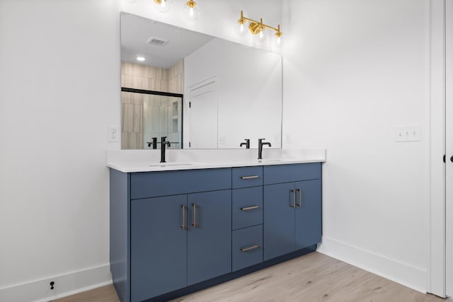 2522 E 18th St, Chattanooga, TN 37404 - bathroom featuring double vanity, baseboards, wood finished floors, and a tile shower