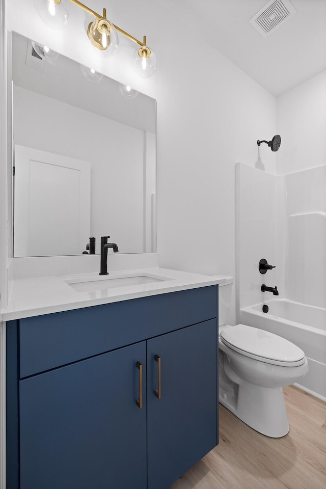 2522 E 18th St, Chattanooga, TN 37404 - full bath featuring toilet, wood finished floors, vanity, and shower / washtub combination