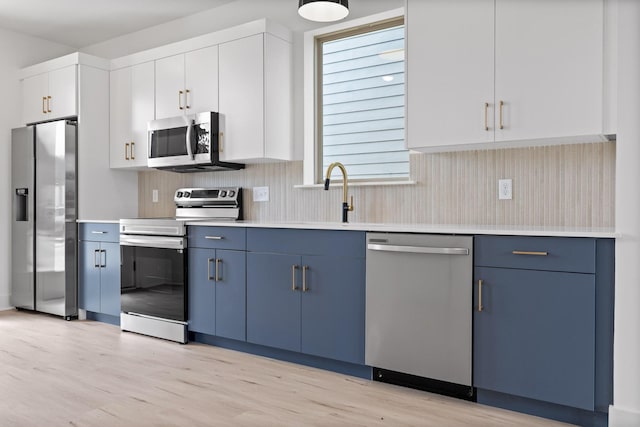 2522 E 18th St, Chattanooga, TN 37404 - kitchen with appliances with stainless steel finishes, light wood-style floors, light countertops, and tasteful backsplash