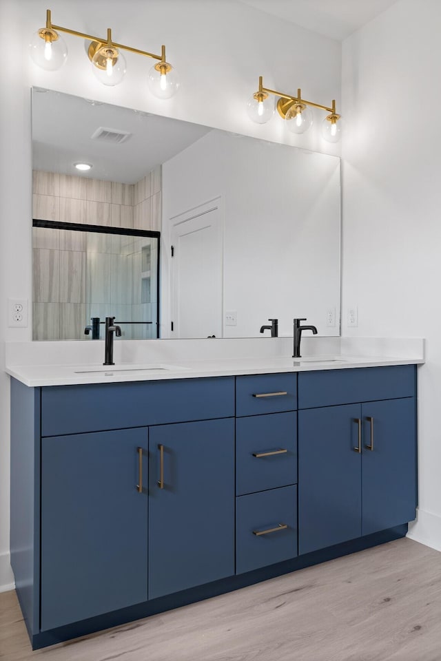 2522 E 18th St, Chattanooga, TN 37404 - full bathroom featuring double vanity, wood finished floors, a shower stall, and baseboards