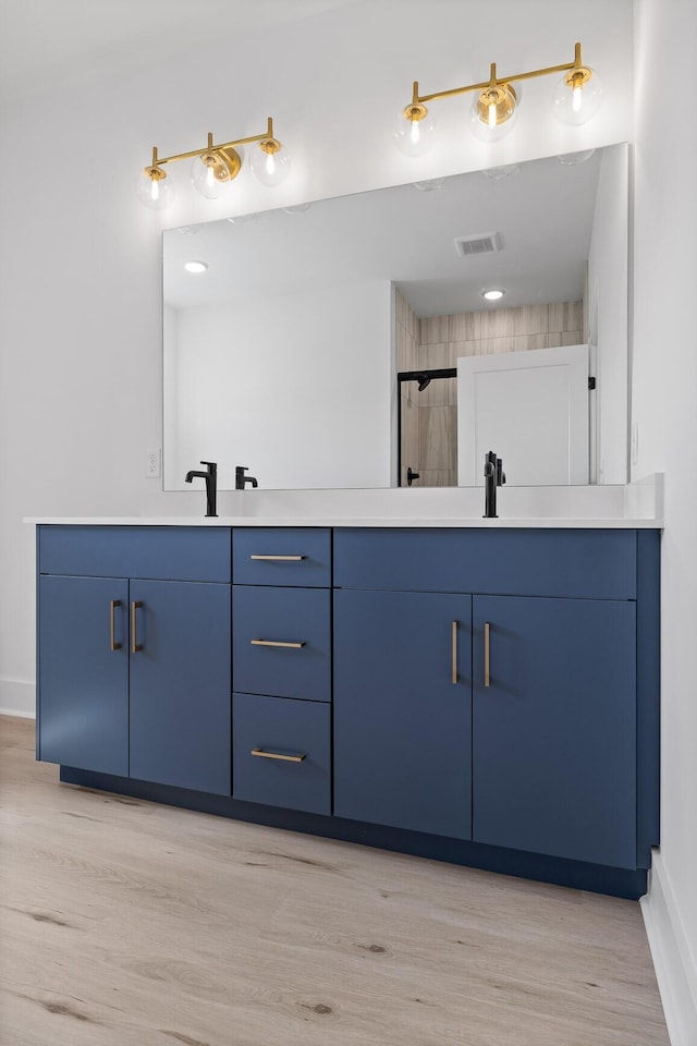 2522 E 18th St, Chattanooga, TN 37404 - bathroom with double vanity, wood finished floors, baseboards, and a shower