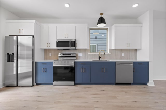 2522 E 18th St, Chattanooga, TN 37404 - kitchen featuring appliances with stainless steel finishes, a sink, blue cabinets, tasteful backsplash, and recessed lighting