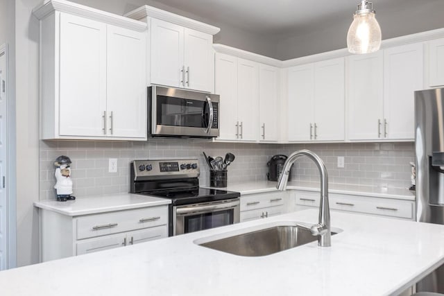 1901 Shadow Green Dr Unit 303, Franklin, TN 37064 - kitchen featuring appliances with stainless steel finishes, a sink, light countertops, and tasteful backsplash