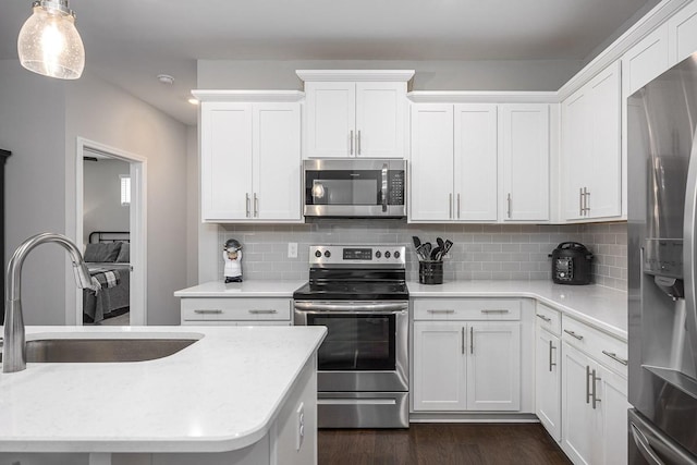 1901 Shadow Green Dr Unit 303, Franklin, TN 37064 - kitchen with stainless steel appliances, a sink, white cabinets, and decorative backsplash