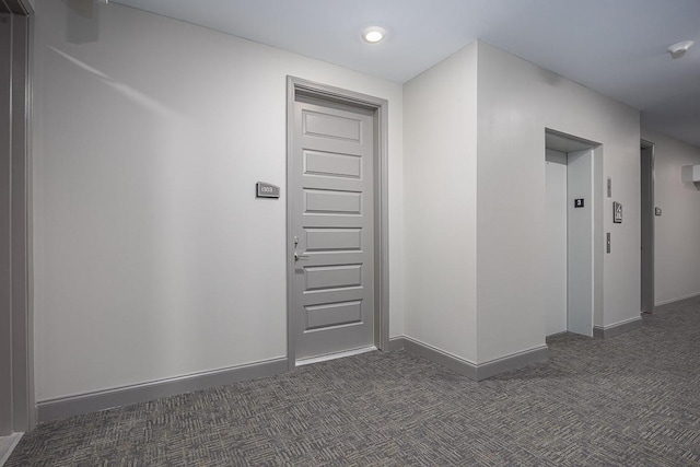 1901 Shadow Green Dr Unit 303, Franklin, TN 37064 - hallway featuring dark carpet, elevator, and baseboards