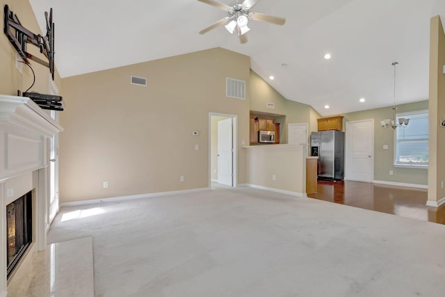 6001 Ten Bears Way, Spring Hill, TN 37174 - unfurnished living room featuring a high end fireplace, a chandelier, a ceiling fan, light carpet, and high vaulted ceiling