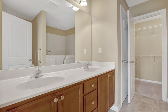 6001 Ten Bears Way, Spring Hill, TN 37174 - full bath with double vanity, tile patterned floors, a spacious closet, and baseboards