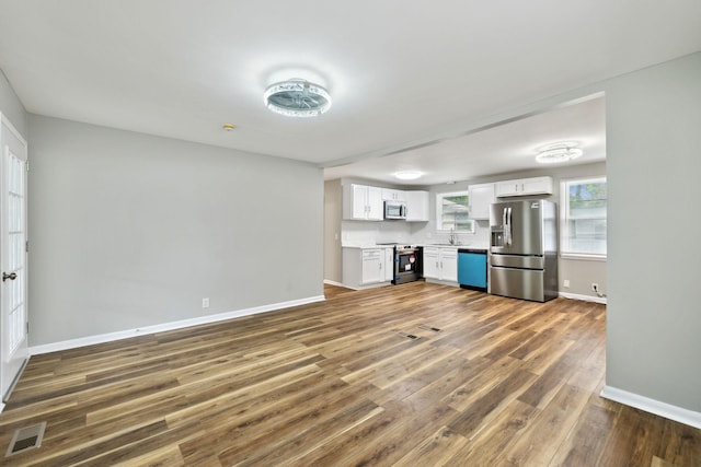 120 Johns St, La Vergne, TN 37086 - unfurnished living room with baseboards, a sink, and wood finished floors