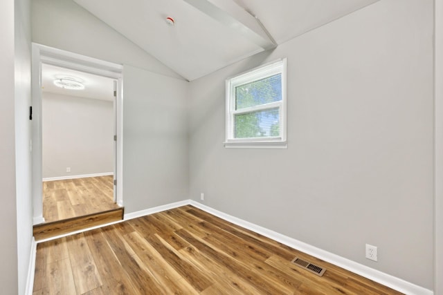 120 Johns St, La Vergne, TN 37086 - spare room featuring vaulted ceiling, wood finished floors, and baseboards
