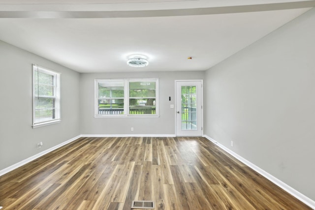 120 Johns St, La Vergne, TN 37086 - empty room featuring wood finished floors, plenty of natural light, and baseboards
