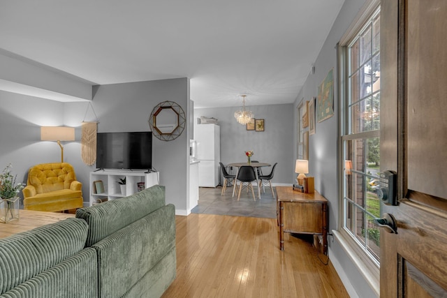 1011 Murfreesboro Rd Unit L3, Franklin, TN 37064 - living room featuring light wood finished floors, healthy amount of natural light, and a chandelier
