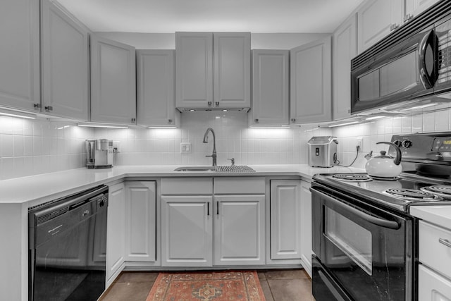 1011 Murfreesboro Rd Unit L3, Franklin, TN 37064 - kitchen with black appliances, a sink, decorative backsplash, light countertops, and dark tile patterned flooring