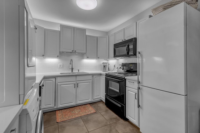 1011 Murfreesboro Rd Unit L3, Franklin, TN 37064 - kitchen featuring black appliances, a sink, light countertops, and backsplash