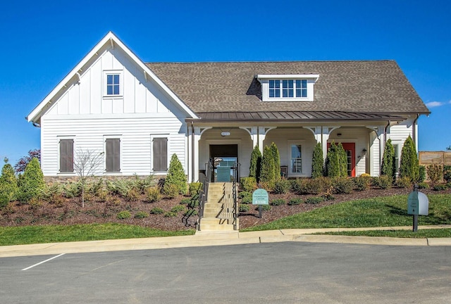 3023 Moultrie Cir, Franklin, TN 37064 - view of front of house with a standing seam roof, covered porch, a shingled roof, and board and batten siding