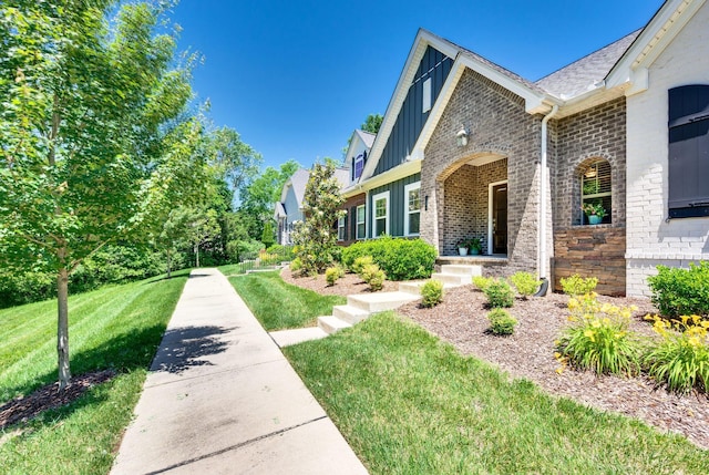 3023 Moultrie Cir, Franklin, TN 37064 - view of side of home featuring board and batten siding, brick siding, and a yard