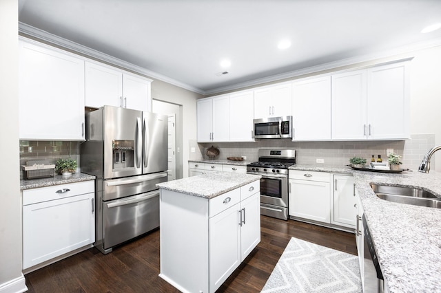 3023 Moultrie Cir, Franklin, TN 37064 - kitchen with appliances with stainless steel finishes, a sink, ornamental molding, tasteful backsplash, and white cabinets
