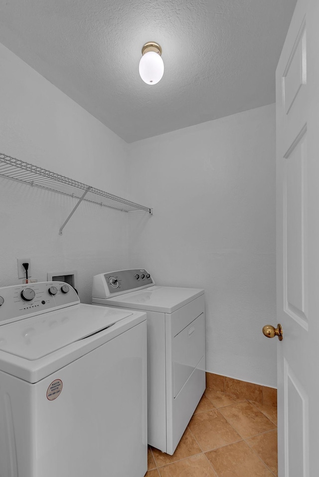 2240 Joann Dr, Spring Hill, TN 37174 - washroom with washer and clothes dryer, a textured ceiling, and baseboards