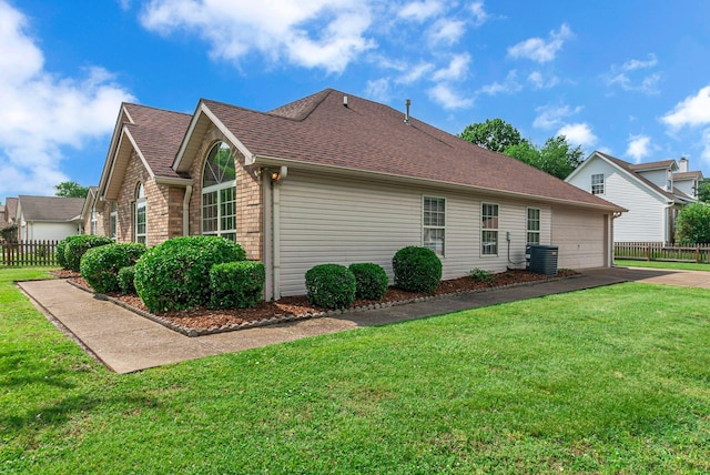 2240 Joann Dr, Spring Hill, TN 37174 - view of home's exterior featuring brick siding, roof with shingles, an attached garage, driveway, and central AC