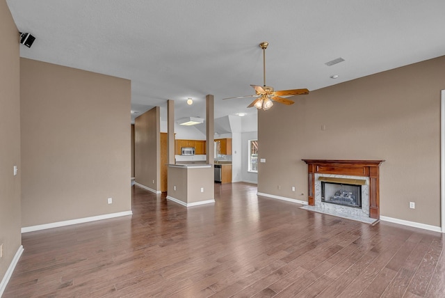 2240 Joann Dr, Spring Hill, TN 37174 - unfurnished living room featuring wood finished floors, a fireplace, ceiling fan, baseboards, and vaulted ceiling