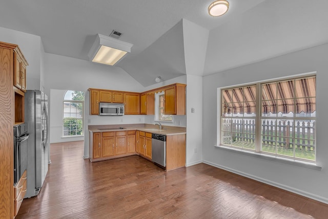 2240 Joann Dr, Spring Hill, TN 37174 - kitchen with appliances with stainless steel finishes, lofted ceiling, light countertops, wood finished floors, and a sink
