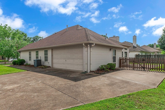 2240 Joann Dr, Spring Hill, TN 37174 - view of side of property featuring central air condition unit, a garage, driveway, a chimney, and a shingled roof