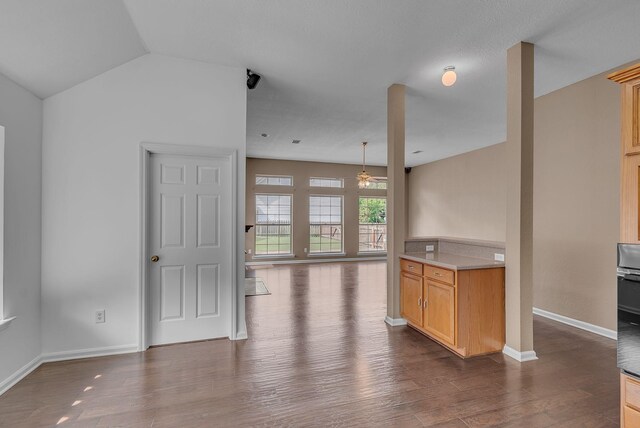 2240 Joann Dr, Spring Hill, TN 37174 - kitchen with dark wood-type flooring, baseboards, vaulted ceiling, open floor plan, and a ceiling fan
