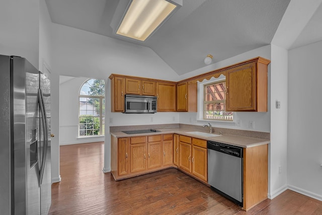 2240 Joann Dr, Spring Hill, TN 37174 - kitchen with stainless steel appliances, a sink, vaulted ceiling, light countertops, and dark wood-style flooring