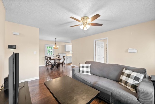 3387 Oak Park Dr, Clarksville, TN 37042 - living area featuring ceiling fan, dark wood finished floors, a chandelier, a textured ceiling, and baseboards