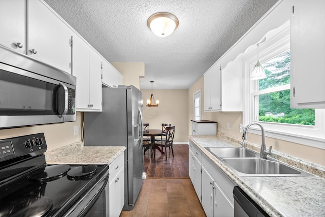 3387 Oak Park Dr, Clarksville, TN 37042 - kitchen with stainless steel appliances, a sink, a chandelier, white cabinets, and a textured ceiling